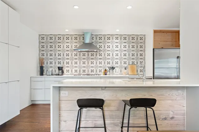 a view of a kitchen with table and chairs