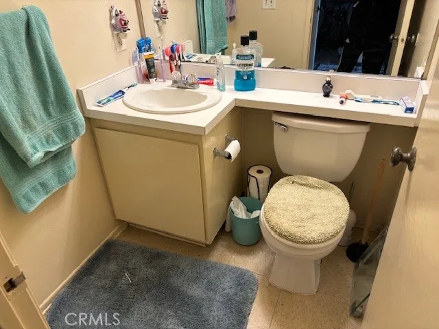 a bathroom with a sink toilet and mirror