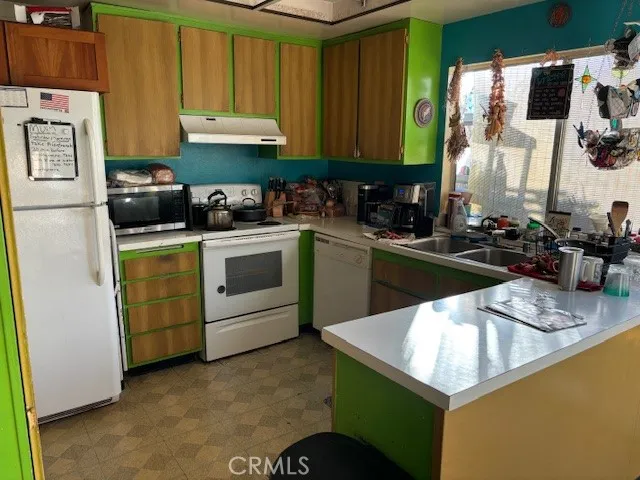 a kitchen with a sink stove and microwave