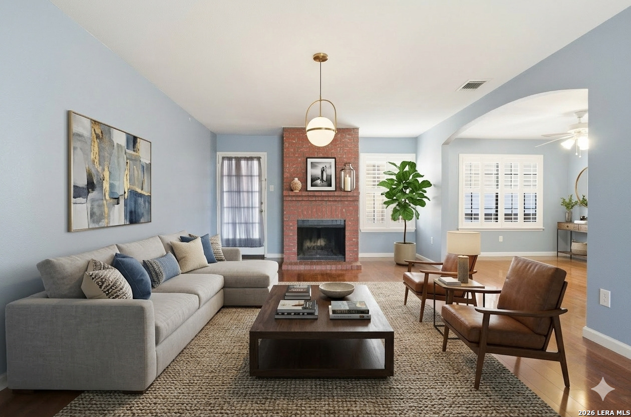 a living room with furniture a fireplace and a chandelier