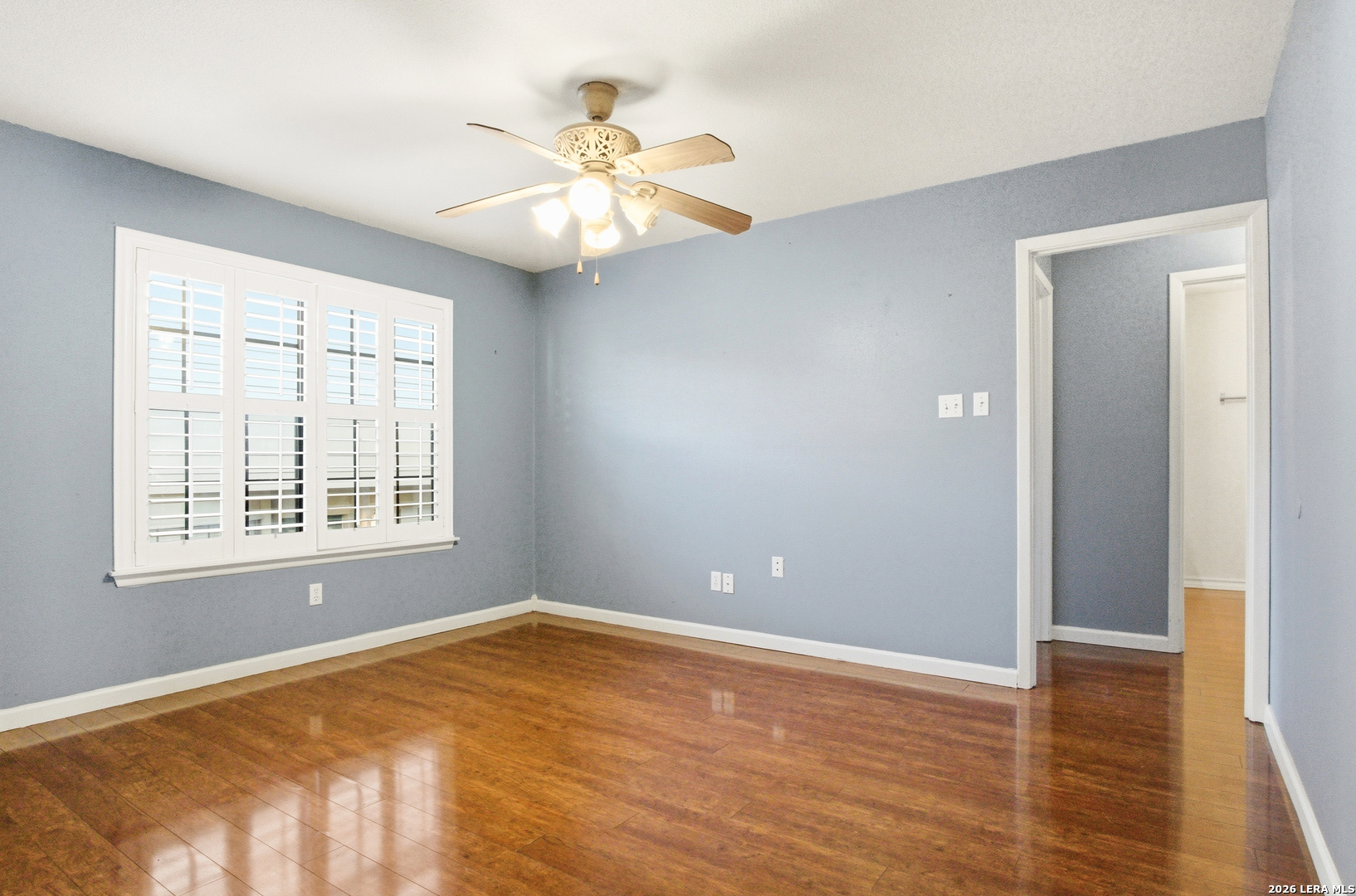 7711 Callaghan Road, Unit 404 San Antonio, TX 78229 - Photo 11 of 39 a view of an empty room with wooden floor and a window