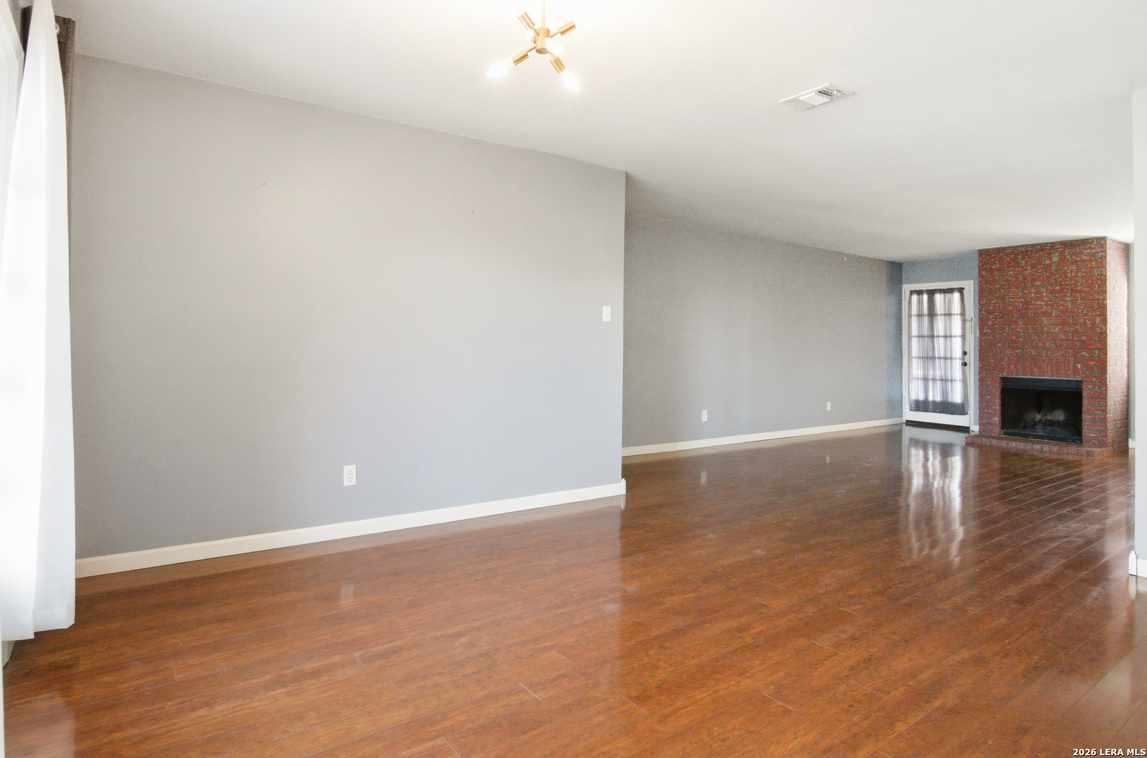7711 Callaghan Road, Unit 404 San Antonio, TX 78229 - Photo 12 of 39 a view of empty room with wooden floor and fan