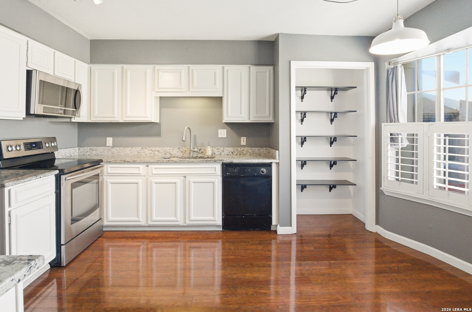 7711 Callaghan Road, Unit 404 San Antonio, TX 78229 - Photo 15 of 39 a kitchen with a sink cabinets and window