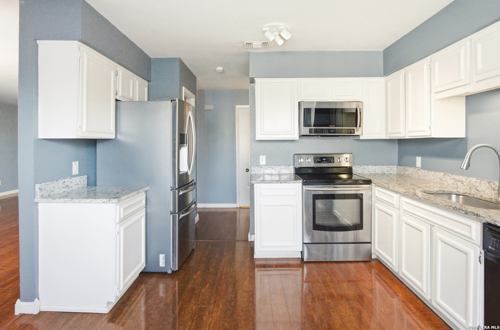 7711 Callaghan Road, Unit 404 San Antonio, TX 78229 - Photo 16 of 39 a kitchen with a refrigerator stove top oven and sink