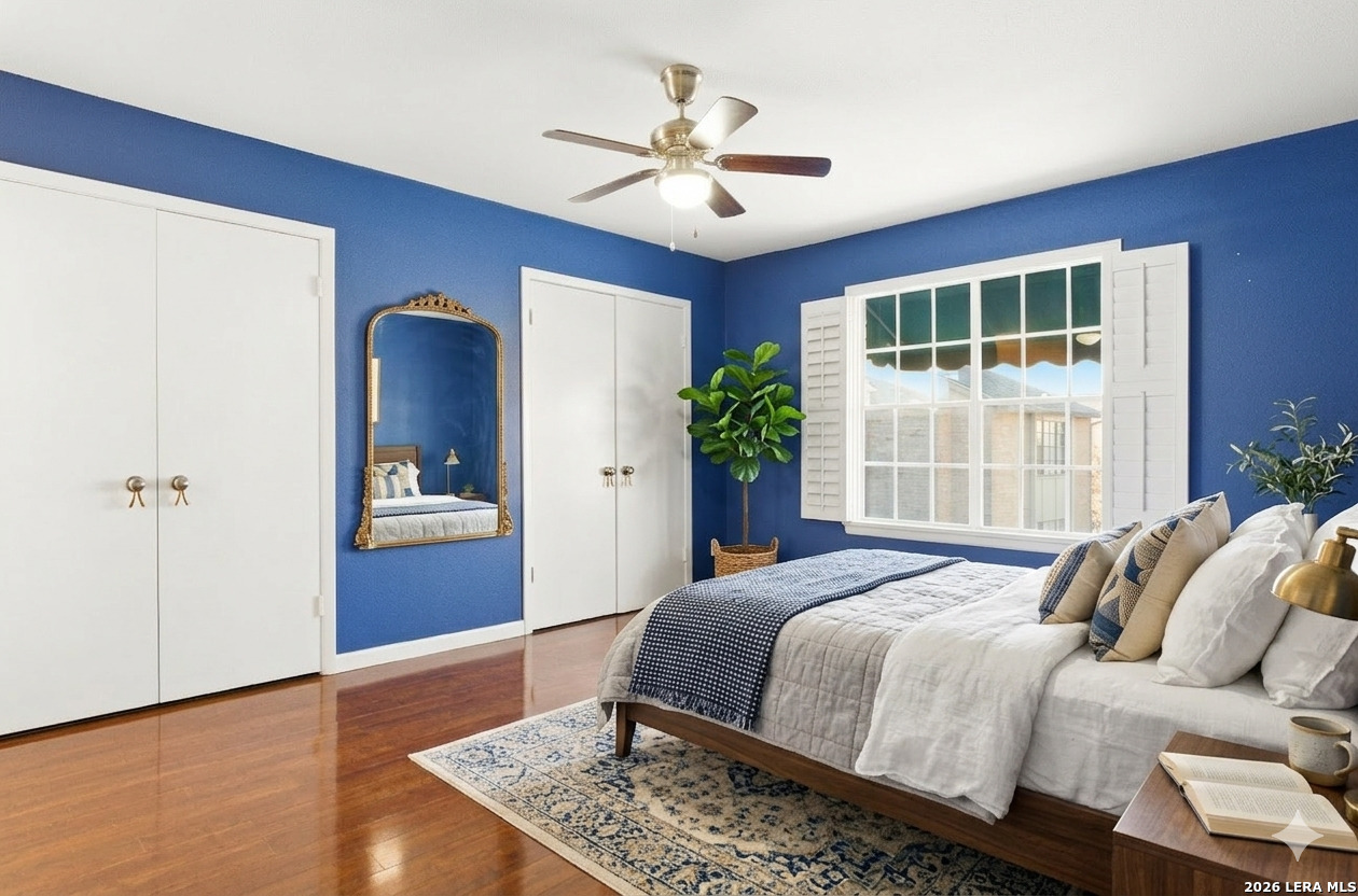 7711 Callaghan Road, Unit 404 San Antonio, TX 78229 - Photo 19 of 39 a bedroom with a large bed and a chandelier