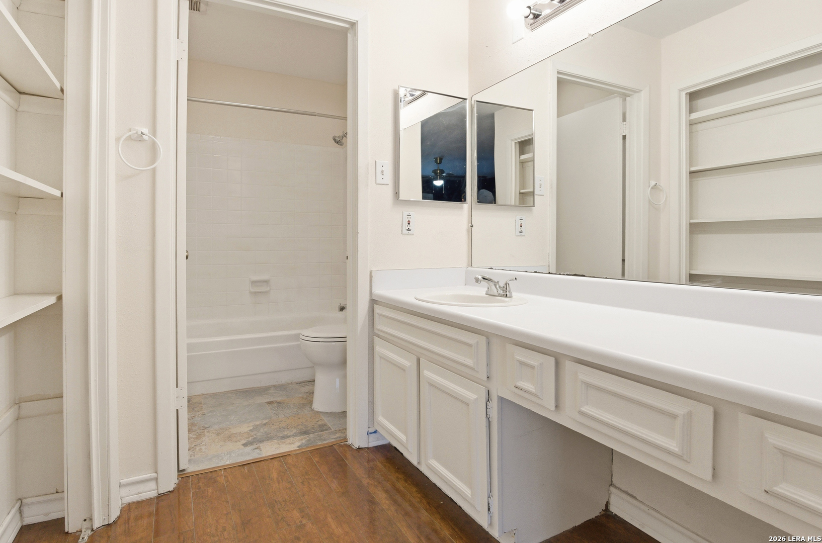 7711 Callaghan Road, Unit 404 San Antonio, TX 78229 - Photo 23 of 39 a bathroom with a double vanity sink and mirror