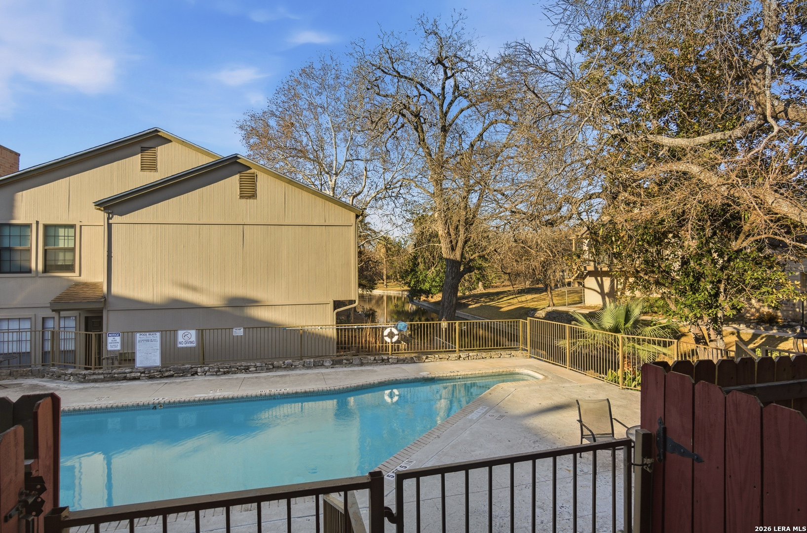 7711 Callaghan Road, Unit 404 San Antonio, TX 78229 - Photo 31 of 39 a view of a house with a swimming pool