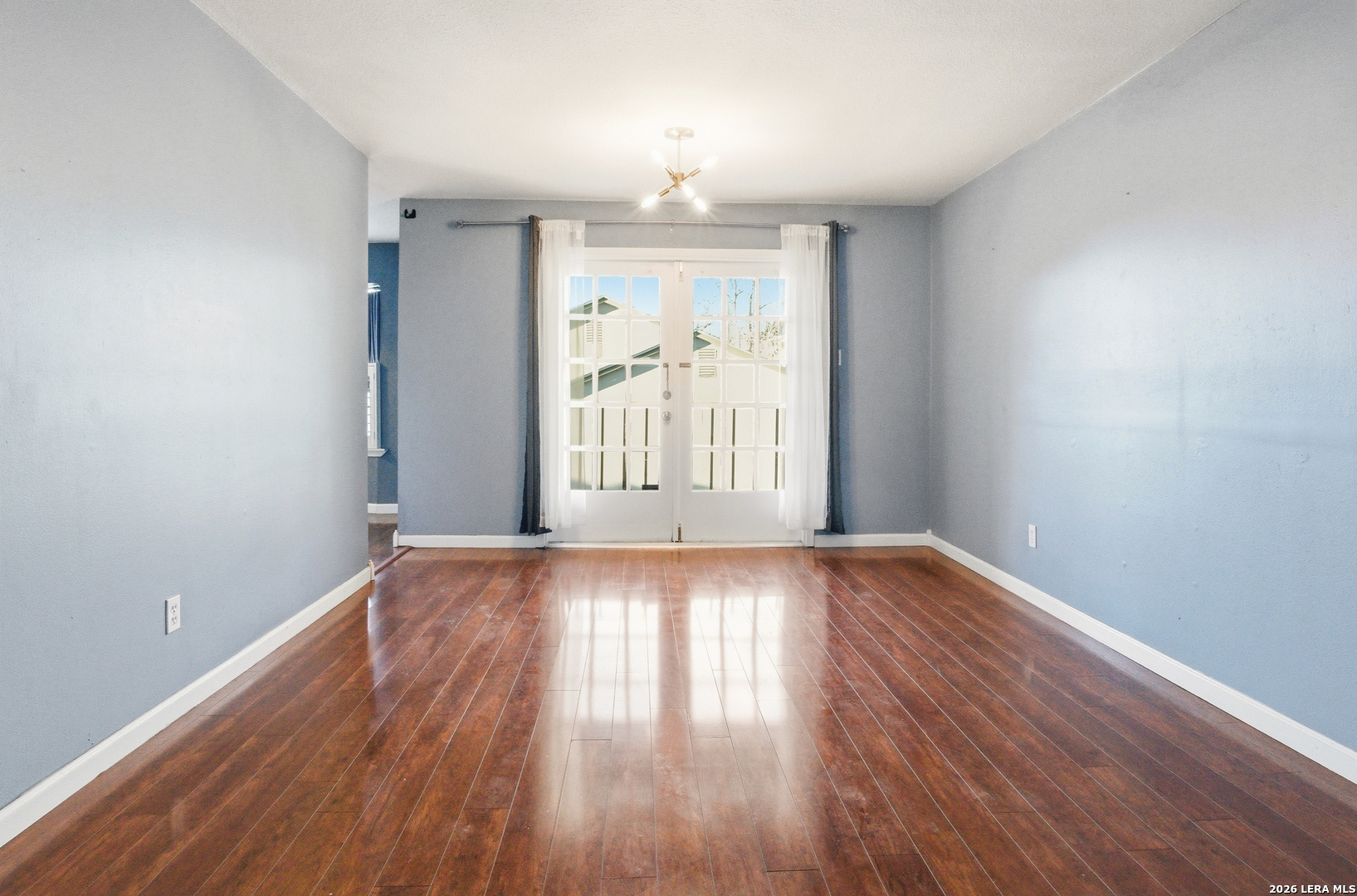 7711 Callaghan Road, Unit 404 San Antonio, TX 78229 - Photo 4 of 39 wooden floor in an empty room with a window