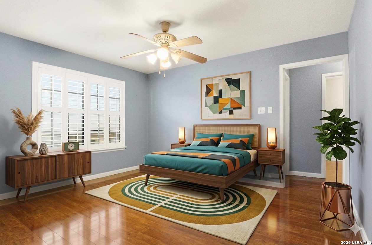 7711 Callaghan Road, Unit 404 San Antonio, TX 78229 - Photo 10 of 39 a bedroom with a bed and a chandelier