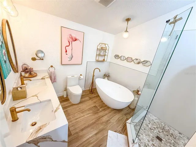 a bathroom with a sink mirror vanity and toilet