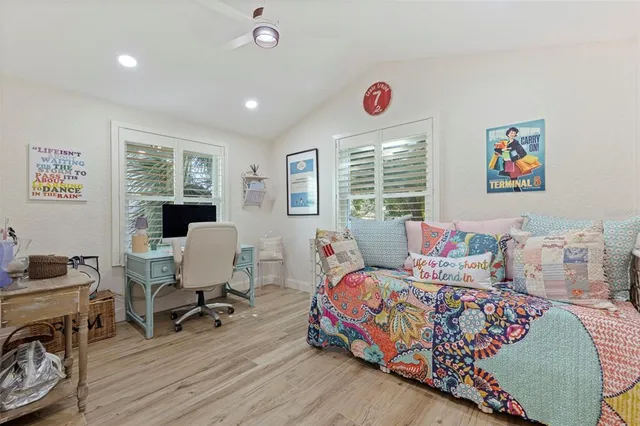 a bedroom with a bed and a desk