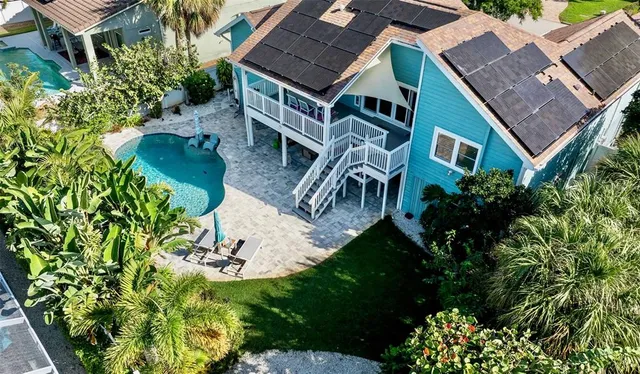 an aerial view of a house with a yard and a garden