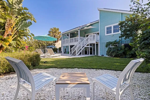 a view of a house with a yard and sitting area