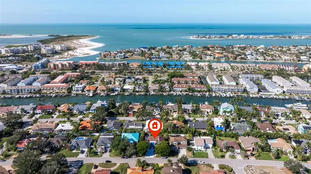 an aerial view of a house with a yard and lake view