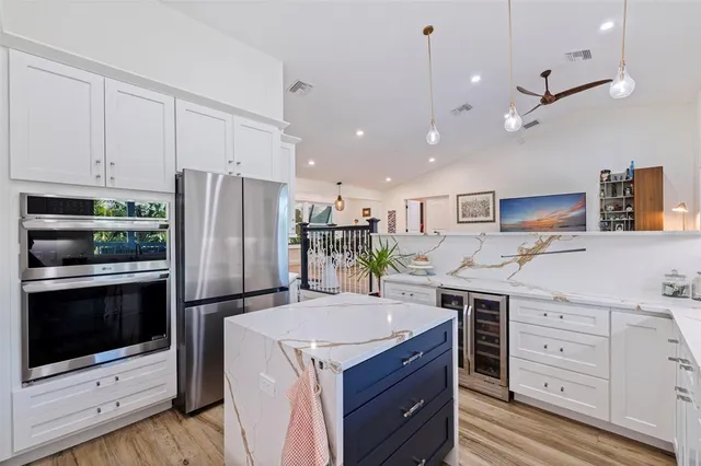 a kitchen with a sink stainless steel appliances and cabinets