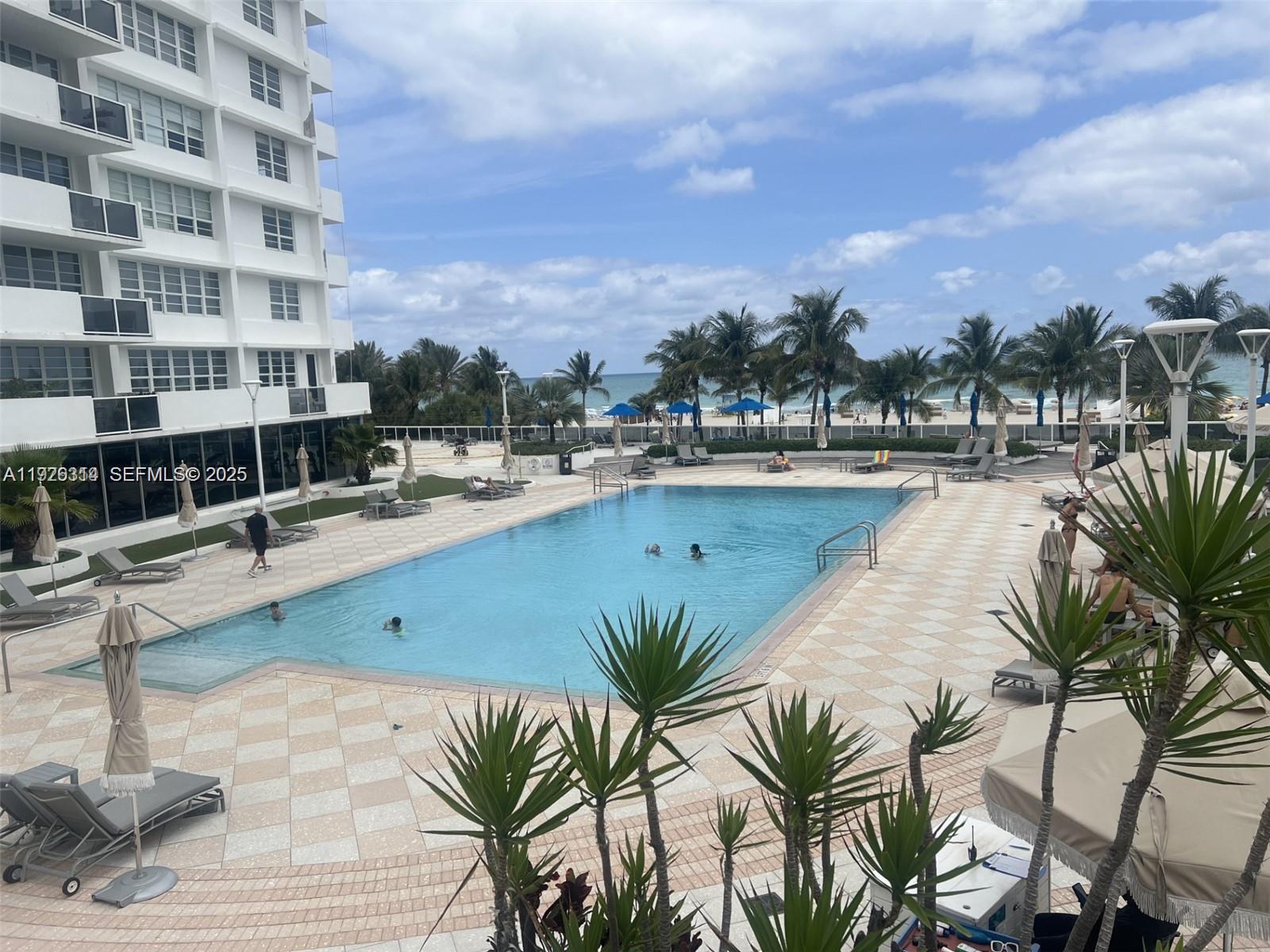 100 Lincoln Road, Unit 430 Miami Beach, FL 33139 - Photo 14 of 17 a view of swimming pool with outdoor seating and buildings in the background