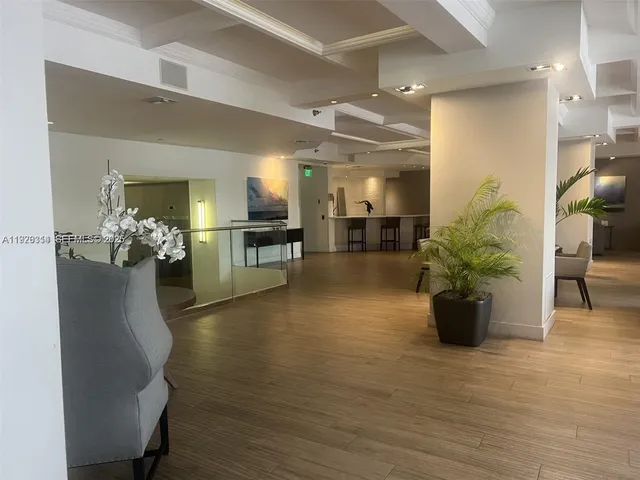 a lobby with furniture and a potted plant