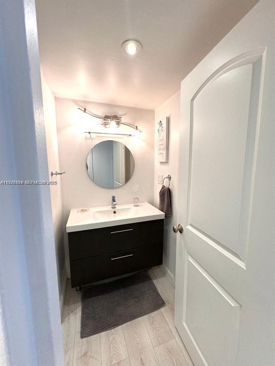 100 Lincoln Road, Unit 430 Miami Beach, FL 33139 - Photo 7 of 17 a bathroom with a sink and mirror