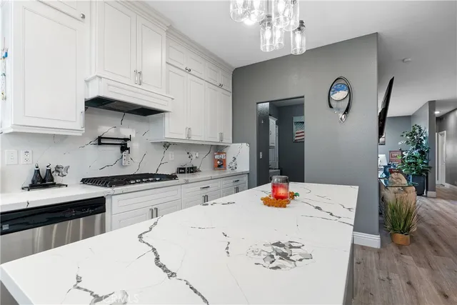 a living room with furniture a fireplace and a dining table with wooden floor