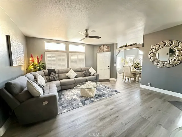 a kitchen with stainless steel appliances granite countertop a sink dishwasher and white cabinets with wooden floor
