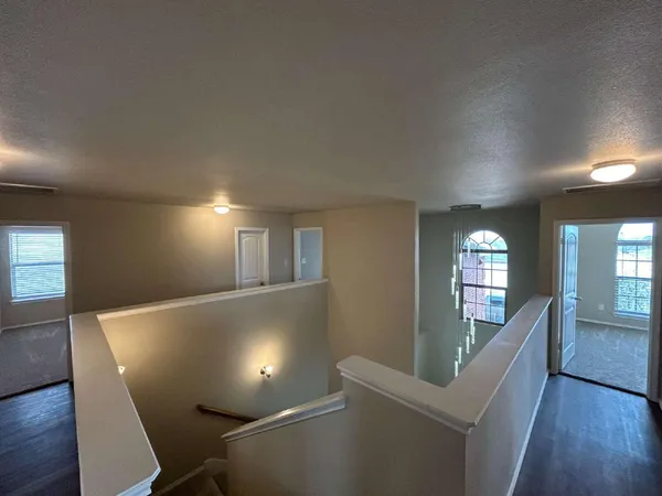 a view of a livingroom with wooden floor and furniture
