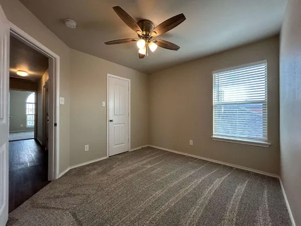 a view of an empty room with a window
