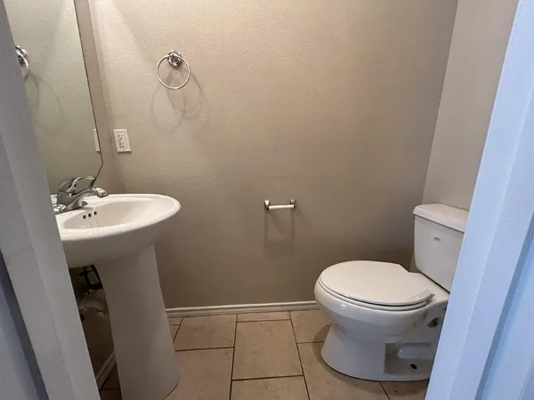 a bathroom with a sink toilet and a mirror