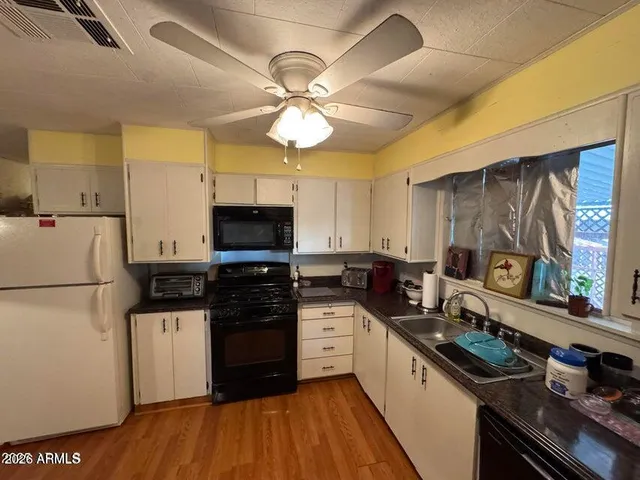 a kitchen with a stove a sink and a refrigerator