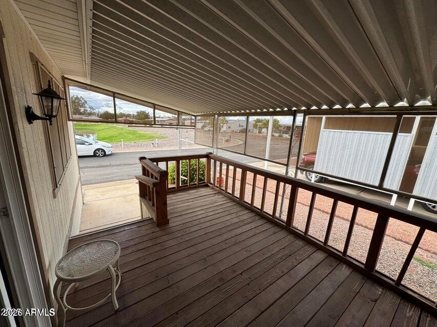 8600 East Broadway Road, Unit 58 Mesa, AZ 85208 - Photo 12 of 13 a porch with wooden floor outdoor seating and stairs