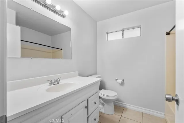 a bathroom with a sink toilet and a mirror