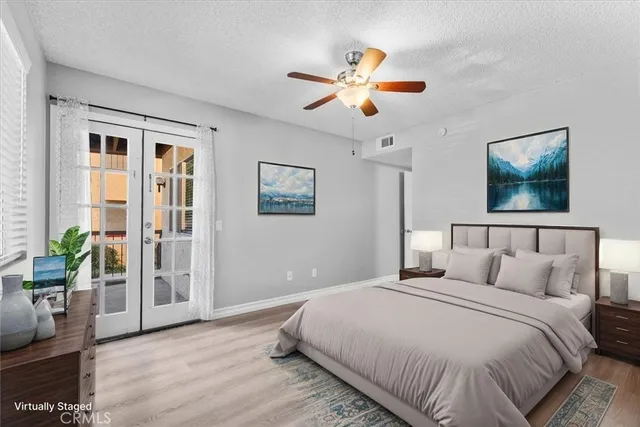 a bedroom with a large bed and a chandelier