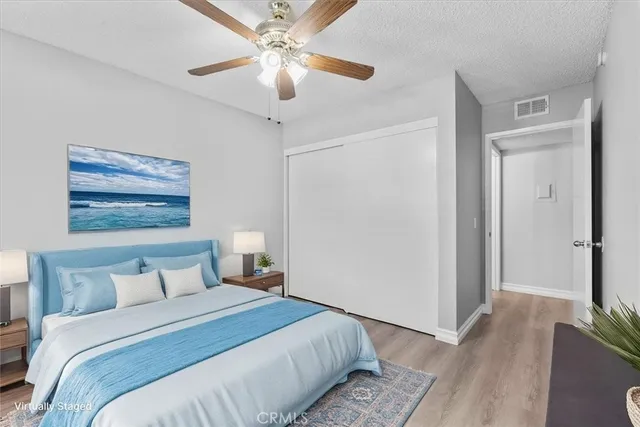 a bedroom with a large bed and a chandelier