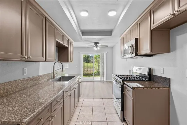 a kitchen that has a sink a stove and a microwave