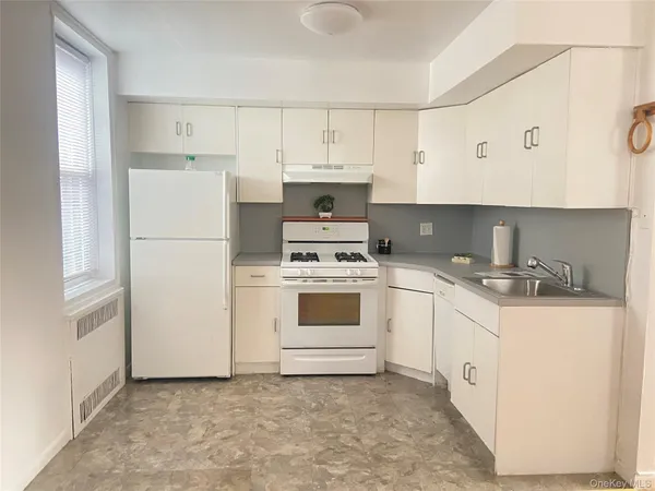 a white refrigerator freezer sitting inside of a kitchen