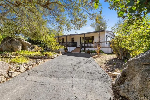 a view of a house with a yard and sitting area