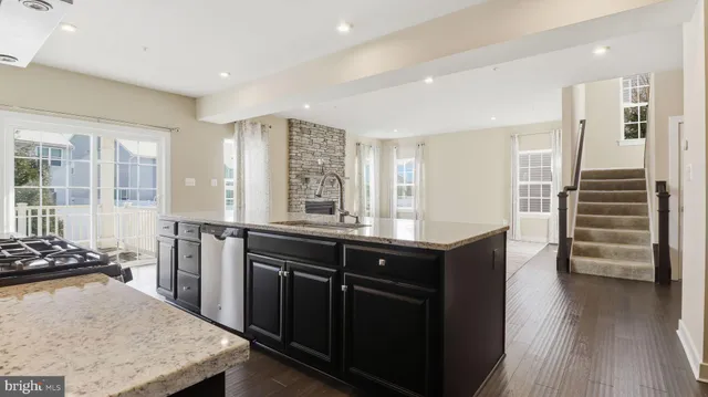 a kitchen with stainless steel appliances granite countertop a stove and a refrigerator