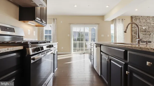 a kitchen with granite countertop a stove and a sink