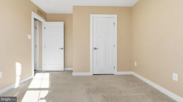 a view of an empty room with windows