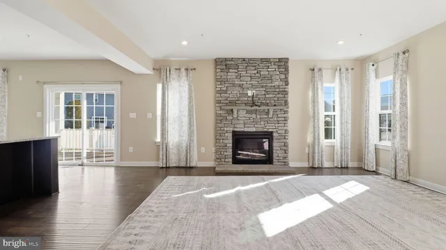 an empty room with windows and a fireplace