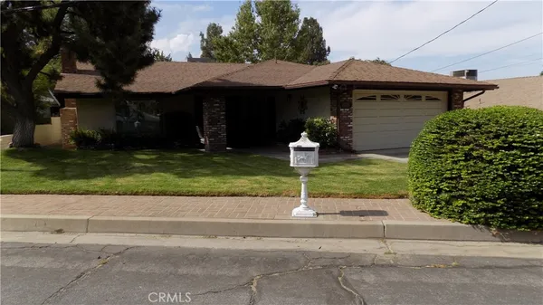 a front view of a house with a yard garage and outdoor seating