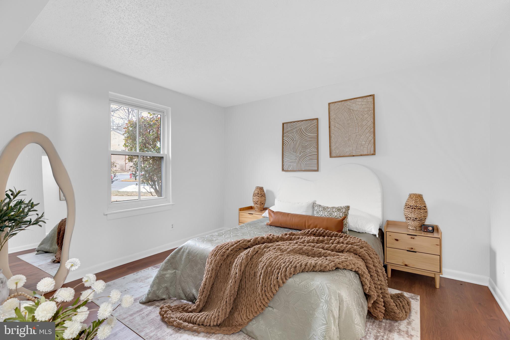 11637 Stoneview Square, Unit 2B Reston, VA 20191 - Photo 19 of 31 a bedroom with a bed and wooden floor