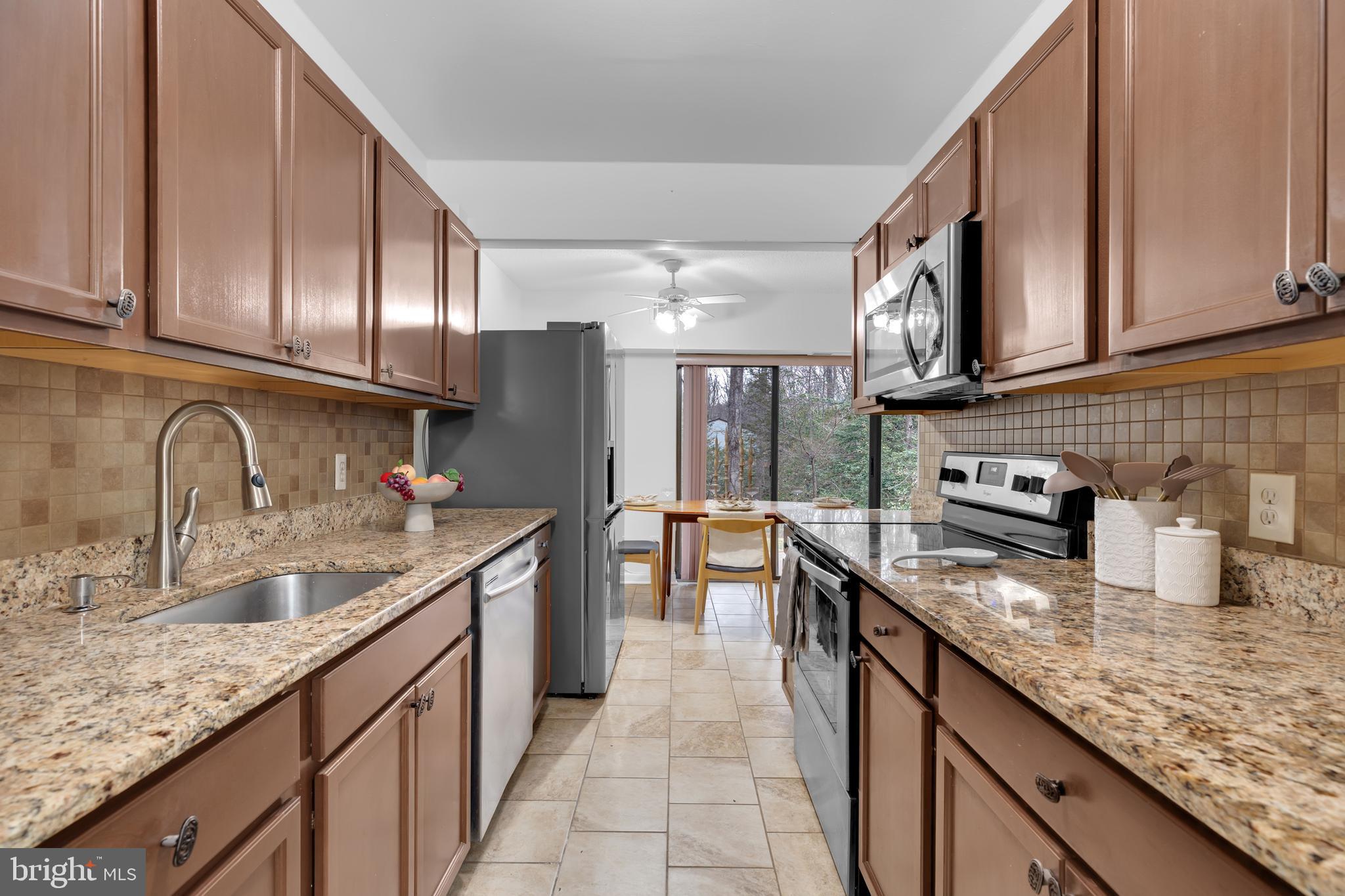 11637 Stoneview Square, Unit 2B Reston, VA 20191 - Photo 5 of 31 a kitchen with stainless steel appliances granite countertop a sink stove and cabinets