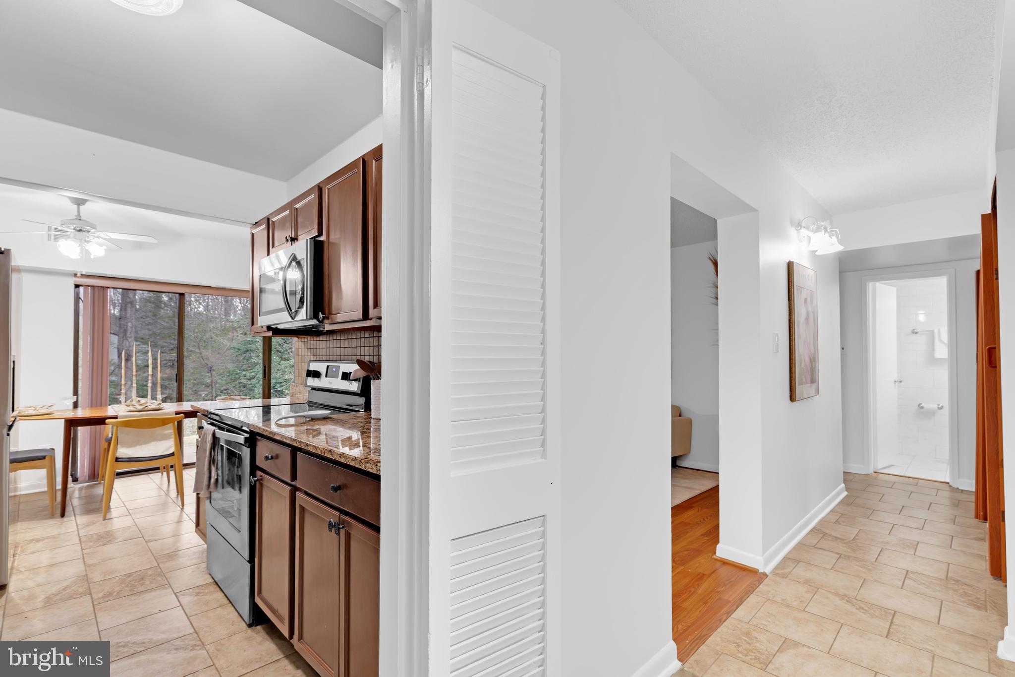 11637 Stoneview Square, Unit 2B Reston, VA 20191 - Photo 7 of 31 a kitchen with stainless steel appliances a stove top oven a sink dishwasher and a refrigerator