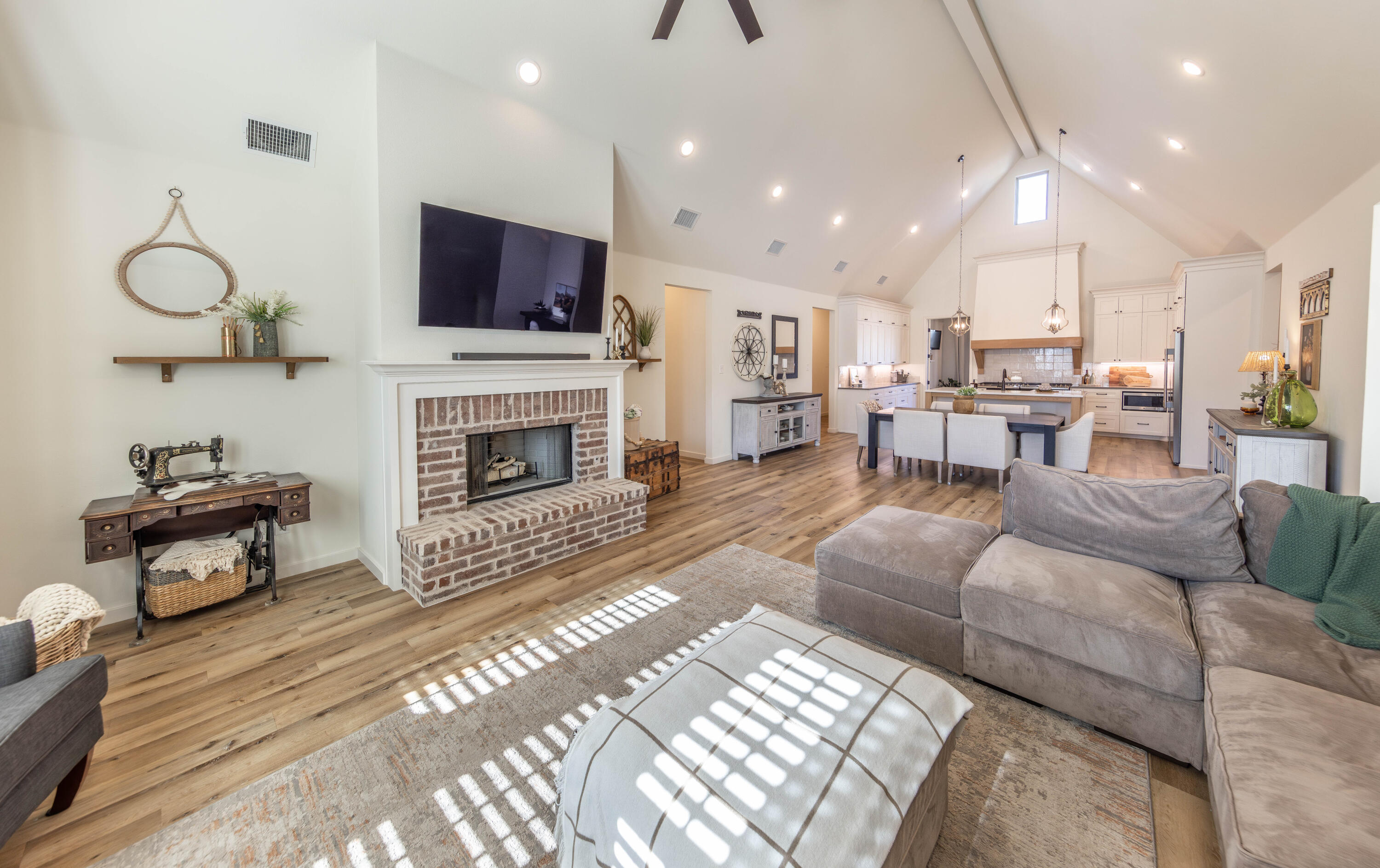 3816 128th Street Lubbock, TX 79423 - Photo 15 of 38 a living room with furniture a fireplace and a flat screen tv
