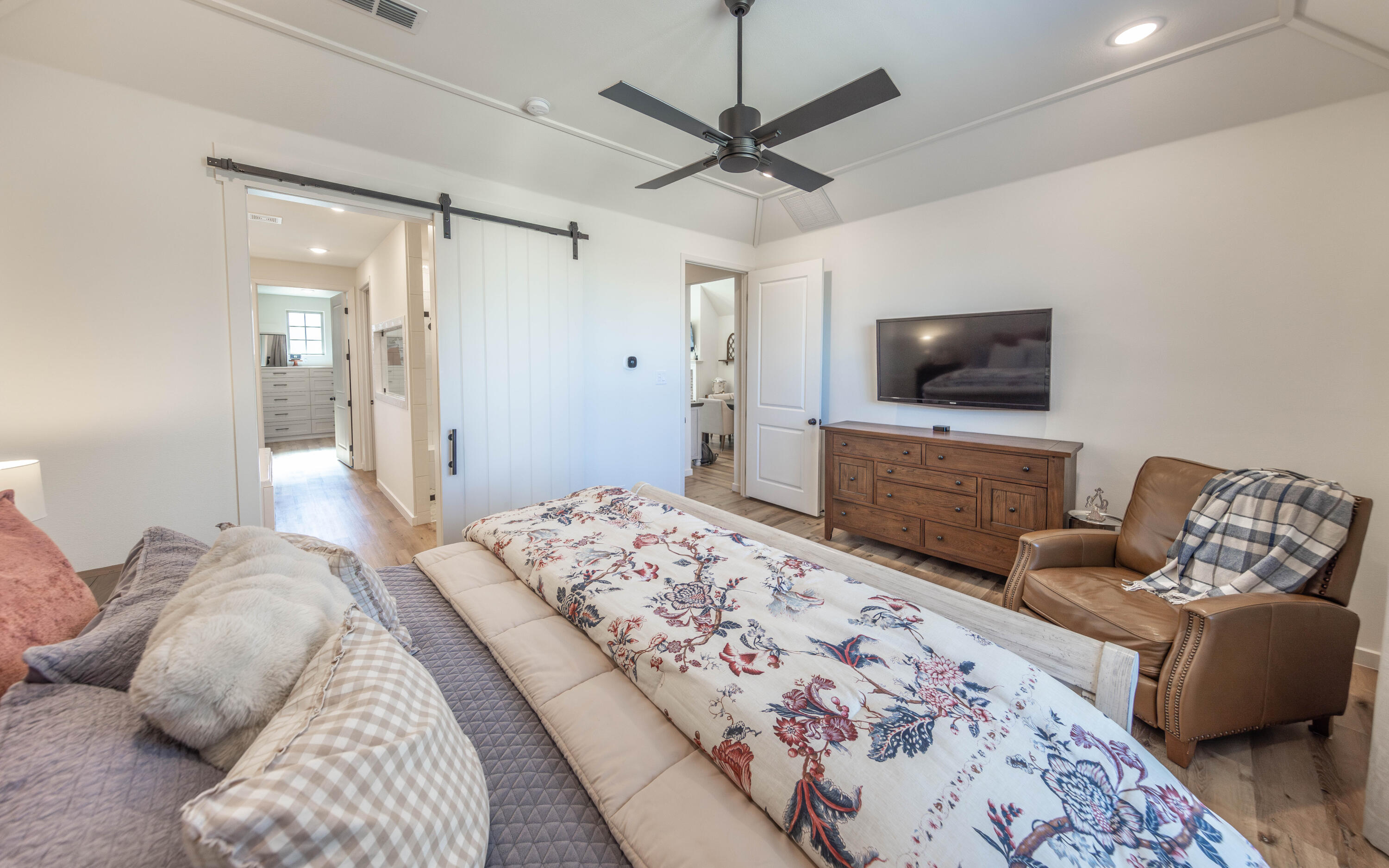 3816 128th Street Lubbock, TX 79423 - Photo 20 of 38 a bedroom with a bed and a flat screen tv