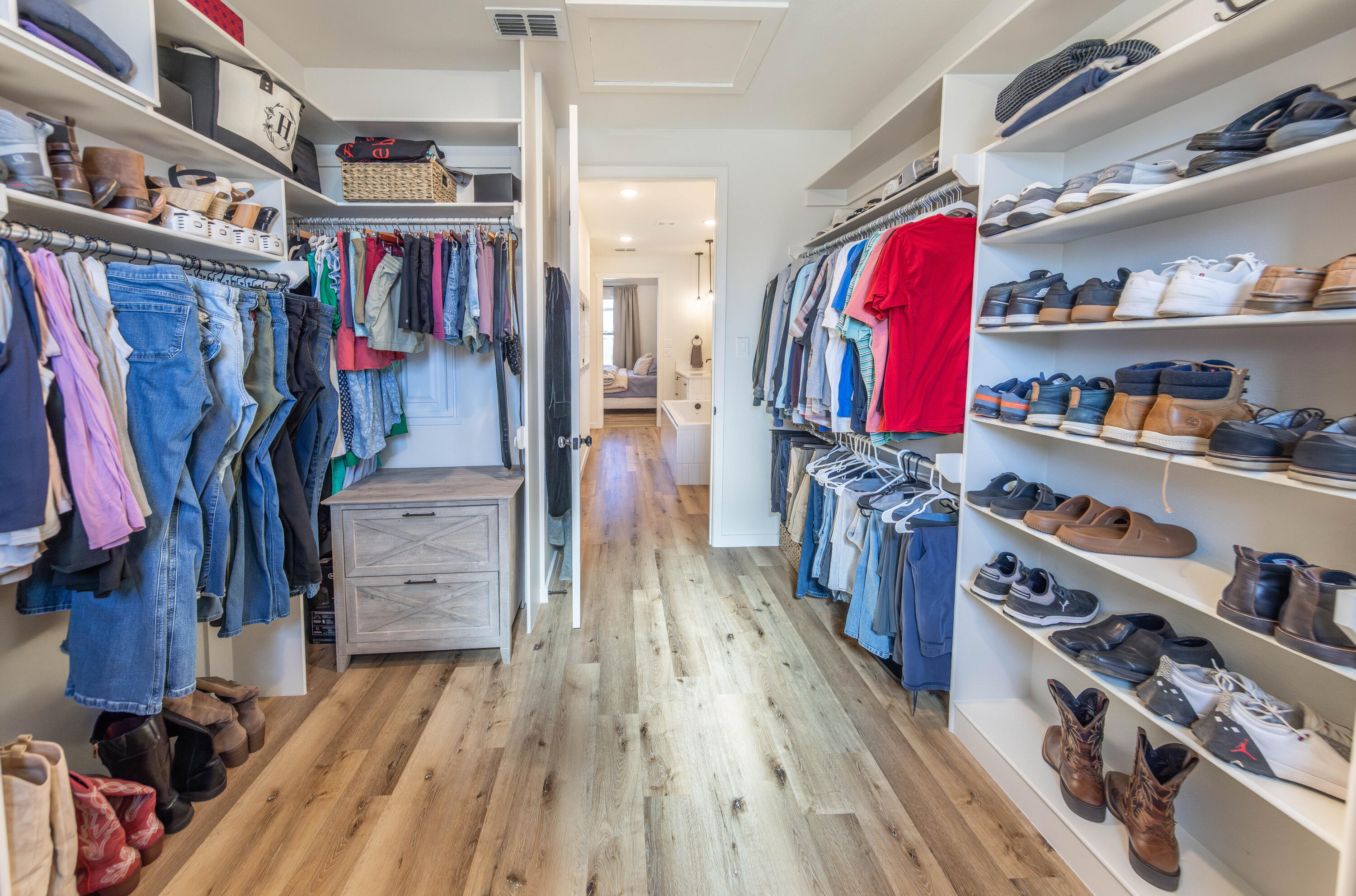 3816 128th Street Lubbock, TX 79423 - Photo 24 of 38 a view of walk in closet with clothes and shoes