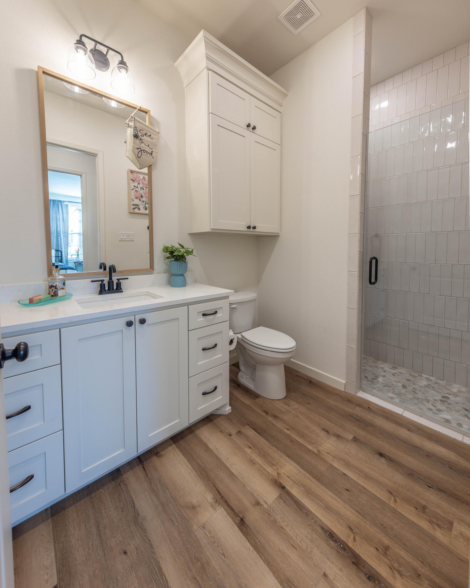 3816 128th Street Lubbock, TX 79423 - Photo 26 of 38 a bathroom with a sink a toilet a large mirror and shower