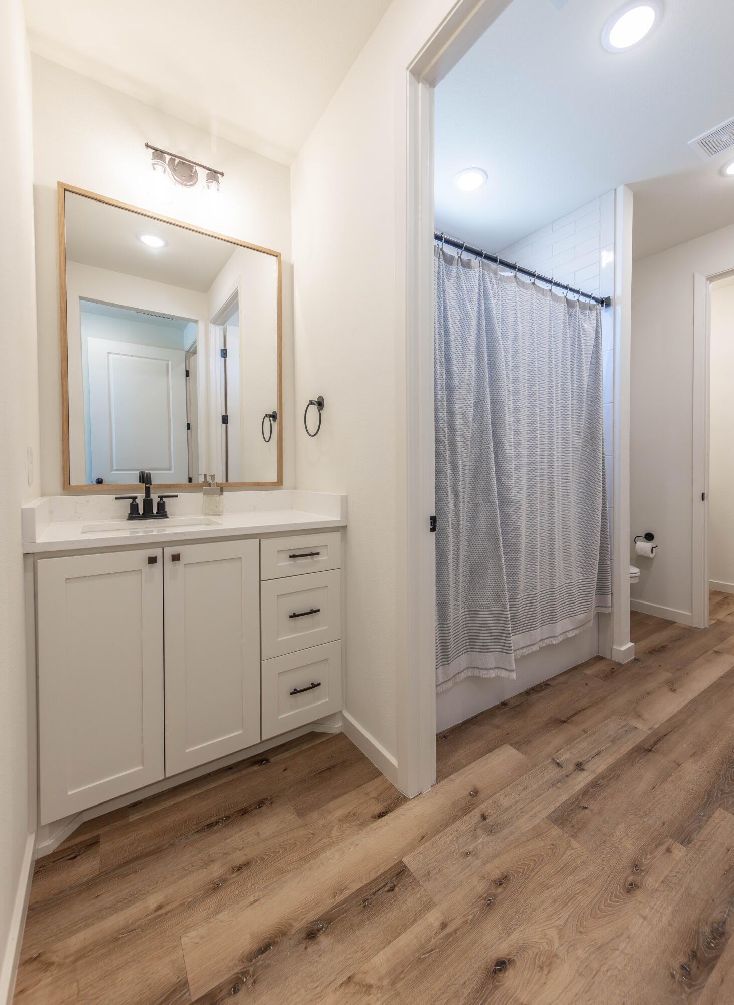 3816 128th Street Lubbock, TX 79423 - Photo 30 of 38 a bathroom with a sink and a mirror