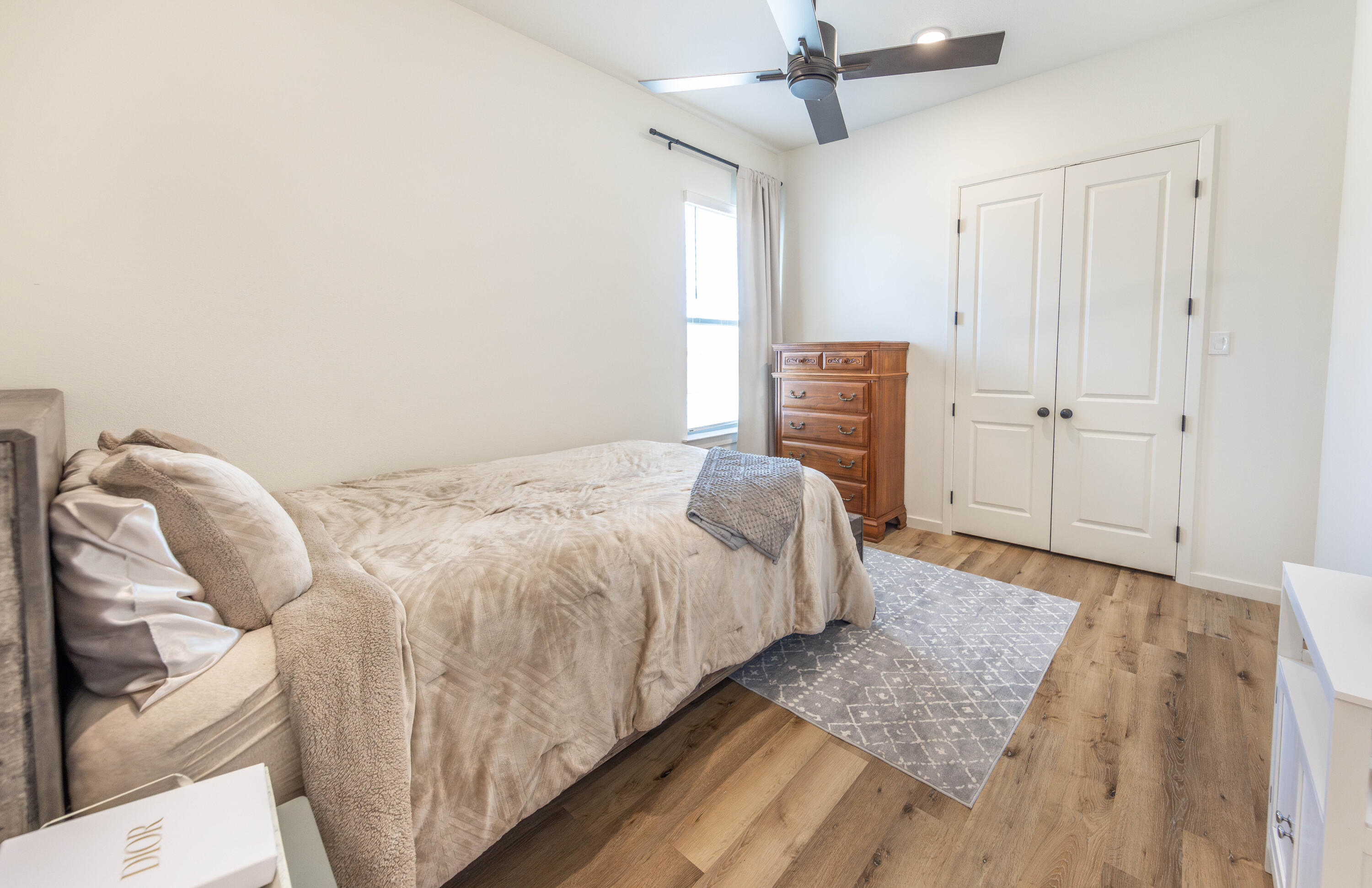 3816 128th Street Lubbock, TX 79423 - Photo 32 of 38 a bedroom with a bed and a chandelier