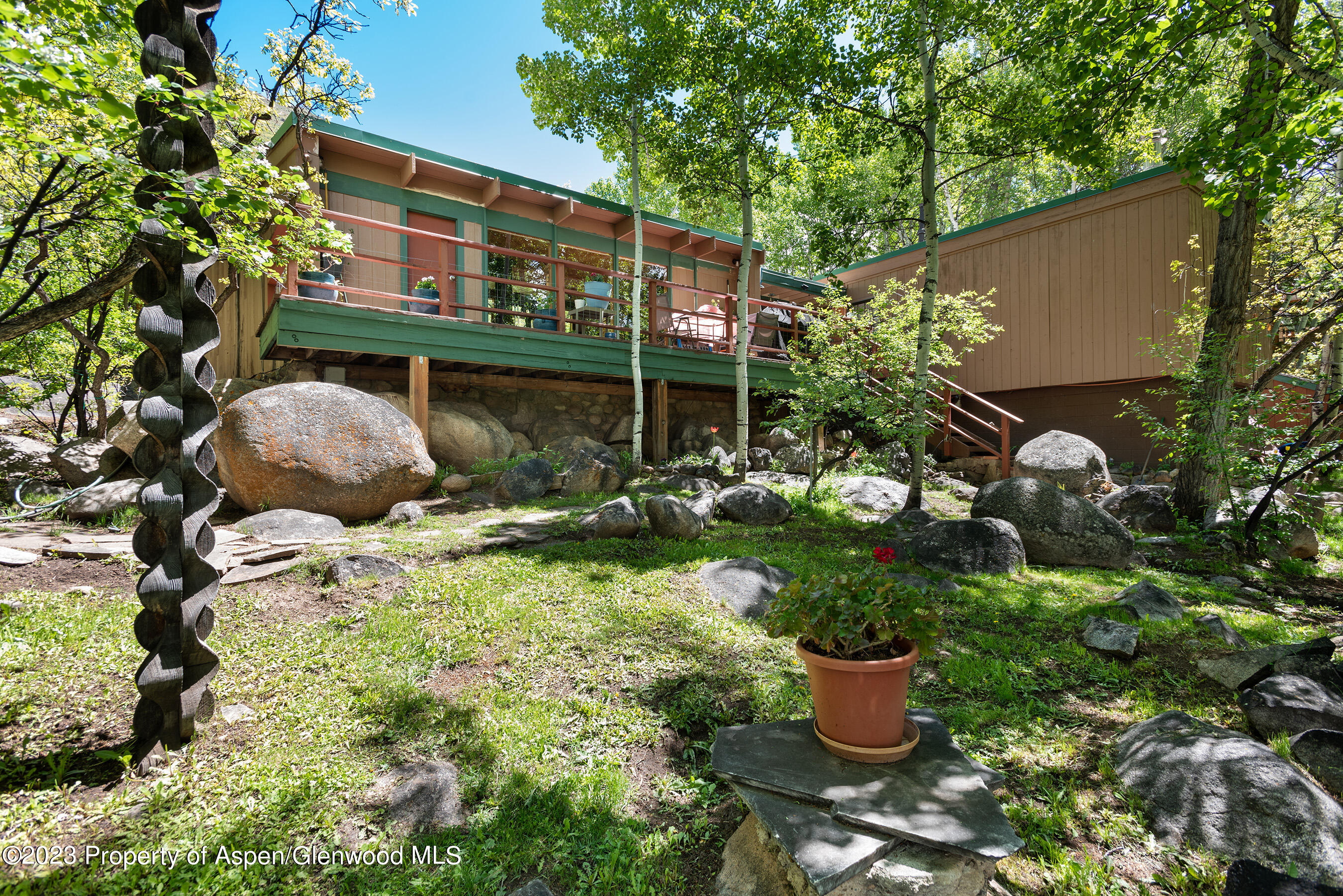 209 East Reds Road Aspen, CO 81612 - Photo 19 of 26 a backyard of a house with a yard and outdoor seating